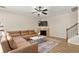 Inviting living room featuring a fireplace, ceiling fan, and wood floors at 805 Pleasant Hill Rd # 171, Lilburn, GA 30047