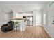 Open-concept living space with stainless steel kitchen appliances and wood floors at 805 Pleasant Hill Rd # 171, Lilburn, GA 30047