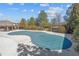 Backyard pool area with a safety cover surrounded by mature trees and greenery, great for privacy at 805 Pleasant Hill Rd # 171, Lilburn, GA 30047