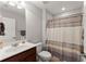 Neutral bathroom with tile floor, cherry vanity, and shower-tub combination at 131 Riverside Ln, Woodstock, GA 30188