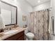 Bathroom featuring a granite vanity top, a toilet, and a tub with a patterned shower curtain at 131 Riverside Ln, Woodstock, GA 30188