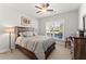 Bedroom with ceiling fan, bright window with backyard views, and rustic wood furniture at 131 Riverside Ln, Woodstock, GA 30188