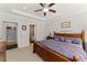 Bedroom with carpet, ceiling fan, dresser, and views to the ensuite bath and closet at 131 Riverside Ln, Woodstock, GA 30188