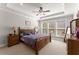 Bedroom with carpeted floors, ceiling fan, and views to the tree-lined backyard at 131 Riverside Ln, Woodstock, GA 30188