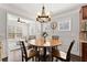 Inviting dining area adjacent to the living room features a round wooden table and hardwood floors at 131 Riverside Ln, Woodstock, GA 30188