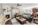 Cozy living room featuring a fireplace, ceiling fan, and stylish furnishings at 131 Riverside Ln, Woodstock, GA 30188