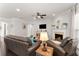 Comfortable living room with leather furniture, a fireplace, lots of natural light, and hardwood floors at 131 Riverside Ln, Woodstock, GA 30188