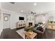 Bright living room features a cozy fireplace, hardwood floors, neutral paint, and a ceiling fan at 131 Riverside Ln, Woodstock, GA 30188