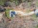 Aerial view of new construction home featuring a curved driveway on wooded lot at 255 Olde Oak Dr, Jonesboro, GA 30238