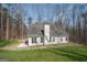 Back view of house with large lawn, surrounded by a wooded area providing privacy at 255 Olde Oak Dr, Jonesboro, GA 30238