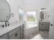 Modern bathroom with dual vanities, soaking tub, and sleek fixtures at 255 Olde Oak Dr, Jonesboro, GA 30238