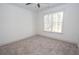 Bright bedroom with carpeted floors featuring a window allowing natural light at 255 Olde Oak Dr, Jonesboro, GA 30238