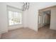 Bright dining room with large window, chandelier and light wood-look flooring at 255 Olde Oak Dr, Jonesboro, GA 30238
