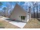 Rear of home featuring a small patio and wooded surround at 255 Olde Oak Dr, Jonesboro, GA 30238