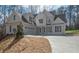 Front elevation features an attached garage, long driveway and well-manicured landscaping at 255 Olde Oak Dr, Jonesboro, GA 30238