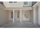 Inviting home front entrance with a covered porch, white columns, bright windows, and a glass-paneled front door at 255 Olde Oak Dr, Jonesboro, GA 30238