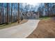 Home view with a long driveway and wooded surroundings at 255 Olde Oak Dr, Jonesboro, GA 30238