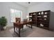 Comfortable home office with natural light, hardwood floors, and a large bookcase at 255 Olde Oak Dr, Jonesboro, GA 30238