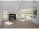 Modern living room with lots of natural light, a fireplace, and an open floor plan at 255 Olde Oak Dr, Jonesboro, GA 30238