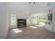 Spacious living room featuring a modern fireplace, large windows, and a breakfast bar at 255 Olde Oak Dr, Jonesboro, GA 30238