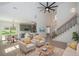 Open-concept living room with a modern kitchen, staircase and lots of natural light at 255 Olde Oak Dr, Jonesboro, GA 30238