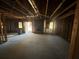 Unfinished basement featuring concrete floors, exposed beams, and fireplace at 424 Independence Dr, Jonesboro, GA 30238