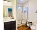 Bathroom featuring a walk-in shower with tile surround and a dark wood vanity at 445 Griffin St, Atlanta, GA 30318