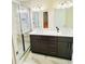 Modern bathroom featuring double vanity, gray cabinets, and glass-enclosed shower at 445 Griffin St, Atlanta, GA 30318