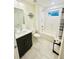 Bright bathroom featuring white subway tiles, marble floors, and modern vanity at 445 Griffin St, Atlanta, GA 30318