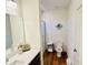 Modern bathroom with a sleek vanity, a toilet, and a tiled shower at 445 Griffin St, Atlanta, GA 30318