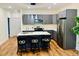 Modern kitchen featuring an island with barstool seating and stainless steel appliances at 445 Griffin St, Atlanta, GA 30318