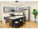 Stylish kitchen featuring gray cabinetry, stainless steel appliances, and an island with seating at 445 Griffin St, Atlanta, GA 30318