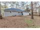 Backyard view of the house, with brick and siding exterior, and a grassy area at 554 Sherwood Oaks Rd, Stone Mountain, GA 30087