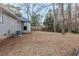 Grey brick house with siding and a partially fenced backyard, with a grassy area at 554 Sherwood Oaks Rd, Stone Mountain, GA 30087