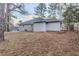 Backyard with a partial grey brick and siding exterior at 554 Sherwood Oaks Rd, Stone Mountain, GA 30087