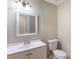 This bathroom features a toilet, sink, mirror, and tiled floors at 554 Sherwood Oaks Rd, Stone Mountain, GA 30087