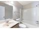 This bathroom features a bathtub, toilet, sink, and mirror at 554 Sherwood Oaks Rd, Stone Mountain, GA 30087