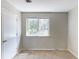 Bedroom featuring a window and neutral carpeting at 554 Sherwood Oaks Rd, Stone Mountain, GA 30087