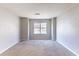 Bright bedroom with large window and neutral walls at 554 Sherwood Oaks Rd, Stone Mountain, GA 30087