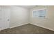 This bedroom is carpeted with a double door closet at 554 Sherwood Oaks Rd, Stone Mountain, GA 30087