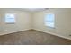 This bedroom is carpeted with two windows at 554 Sherwood Oaks Rd, Stone Mountain, GA 30087