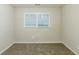 Cozy carpeted bedroom with a window at 554 Sherwood Oaks Rd, Stone Mountain, GA 30087