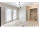 This dining area features tile floors, hanging light, and door with blinds at 554 Sherwood Oaks Rd, Stone Mountain, GA 30087