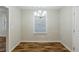 Bright dining room features modern chandelier, a window, and wood floors at 554 Sherwood Oaks Rd, Stone Mountain, GA 30087