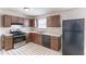 Eat-in kitchen featuring vintage cabinets and black appliances at 554 Sherwood Oaks Rd, Stone Mountain, GA 30087