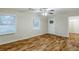 Bright living room features wood floors, a ceiling fan, and natural light from two large windows at 554 Sherwood Oaks Rd, Stone Mountain, GA 30087