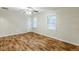 The spacious main bedroom features two windows and wood-look flooring at 554 Sherwood Oaks Rd, Stone Mountain, GA 30087