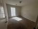 Cozy bedroom featuring a large window for natural light and closet space at 5676 Marbut Rd, Lithonia, GA 30058