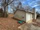 Side view of home shows siding, a one-car garage, and a driveway at 5676 Marbut Rd, Lithonia, GA 30058