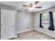 Bedroom featuring a ceiling fan with lights, wood look flooring, and one window with curtains at 2960 Paul Harris Rd, Dallas, GA 30157